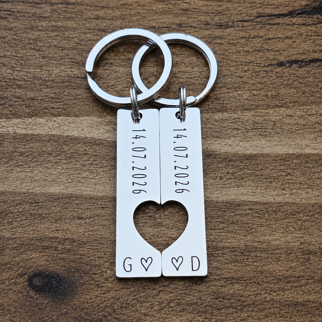 Front view of matching date keyrings forming a heart, with initials G and D and small engraved outline hearts
