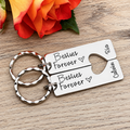 Personalised Besties Forever keyring pair with Ria and Calvin names and a matching heart cut-out, beside an orange rose
