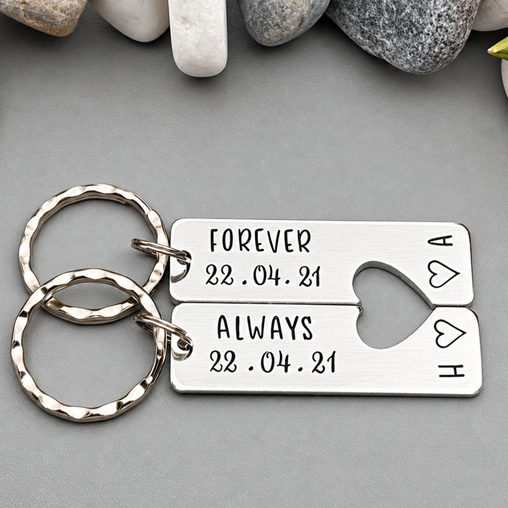 Matching aluminium Forever and Always keyrings arranged horizontally, showing a personalised date, initials and stamped outline hearts
