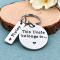 A silver metal keychain with a round disc engraved with 'This Uncle belongs to.