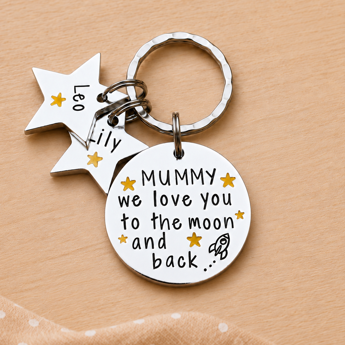 Personalised Mummy moon and back keyring with Leo and Lily star name tags on a peach background
