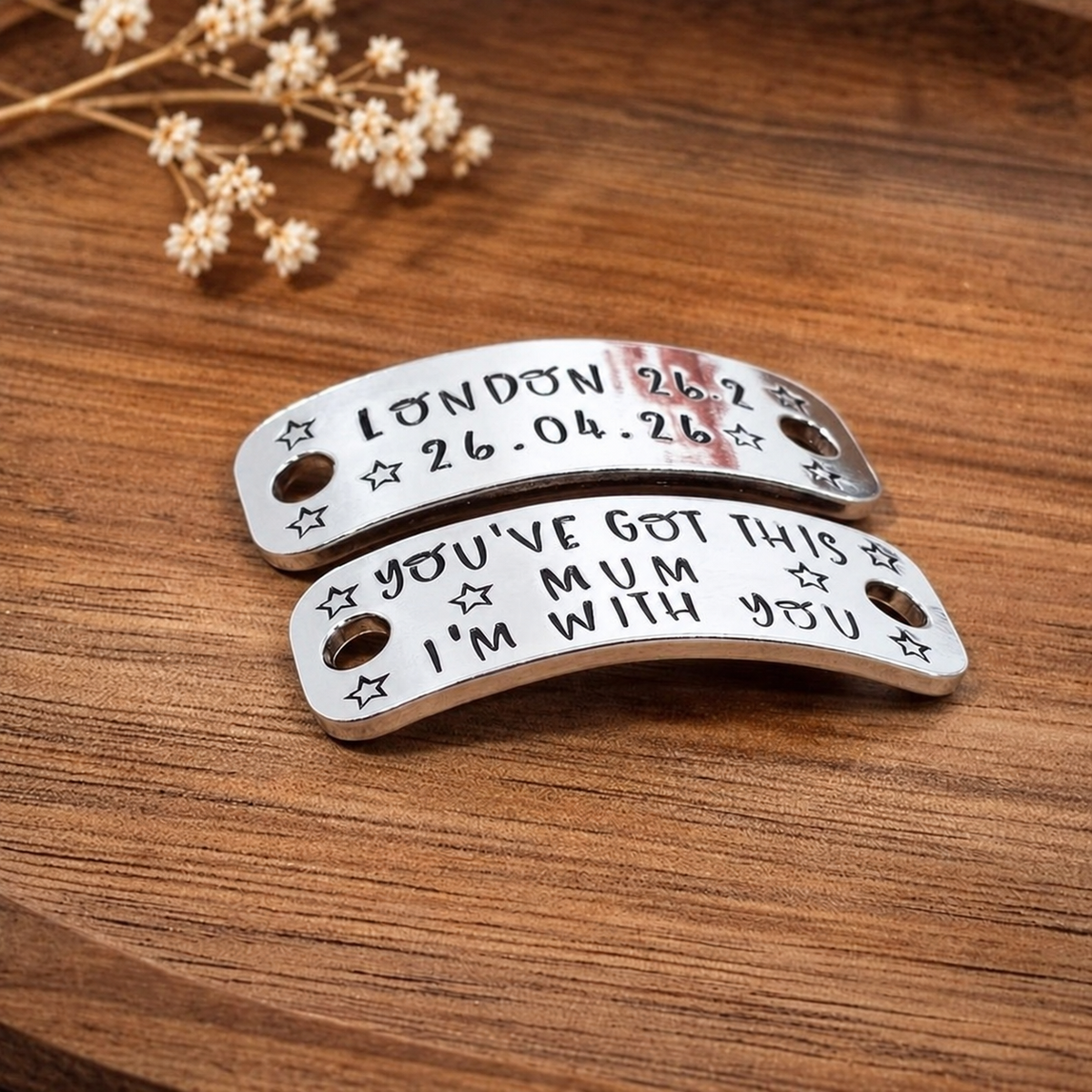 Angled close-up of hand stamped running shoe tags with London race details, stars and You’ve got this Mum, I’m with you message
