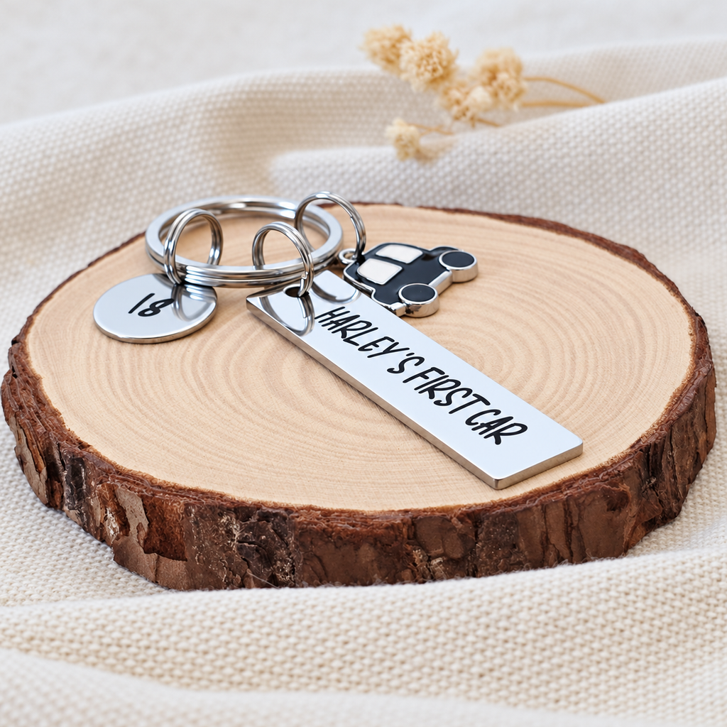 Angled view of Harley's First Car keyring with an engraved 18 age tag and black car charm