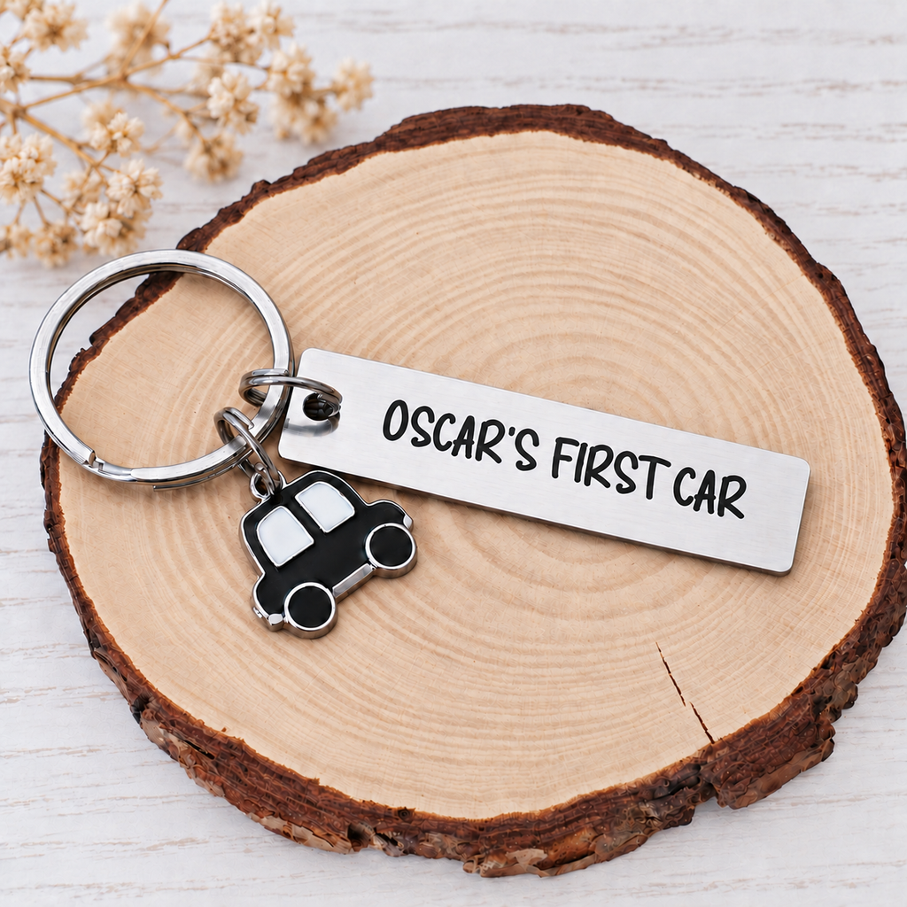 Personalised Oscar's First Car keyring with black car charm on a wooden display
