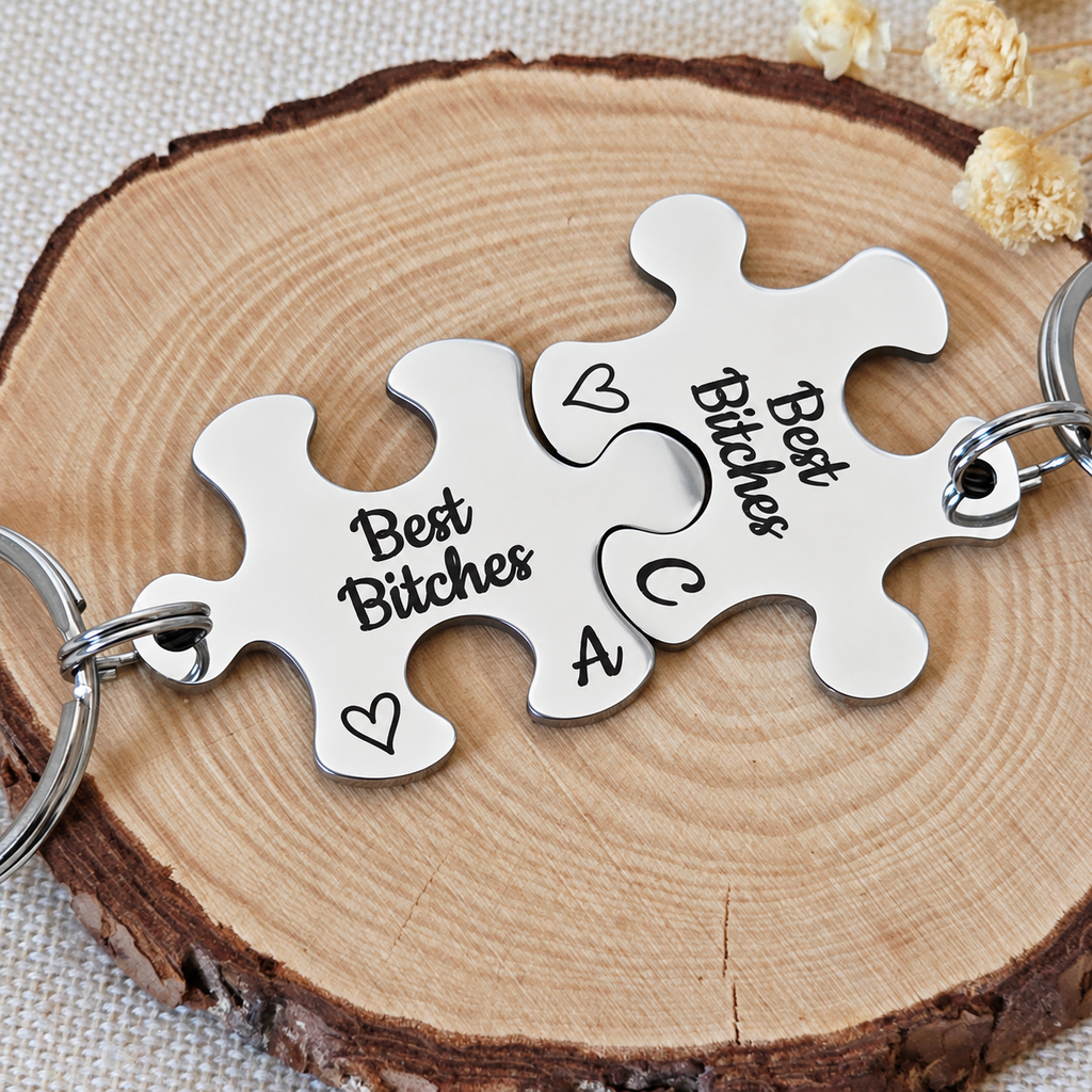 Close-up of a personalised Best Bitches puzzle keyring set with initials A and C on a wood slice
