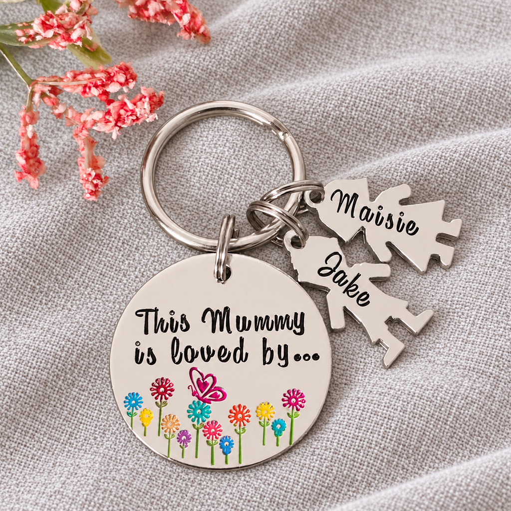 Personalised This Mummy Is Loved By aluminium keyring with colourful flowers, a butterfly and little people charms named Maisie and Jake on linen
