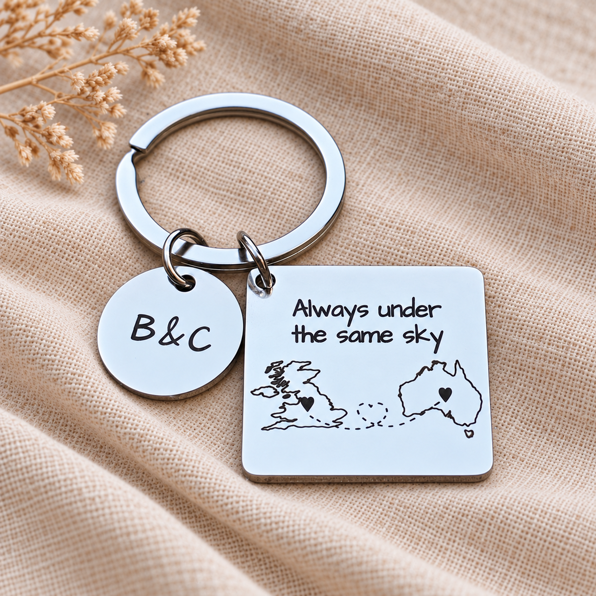 Long distance map keyring with heart details linking the UK and Australia, engraved wording and a round B&C initials charm

