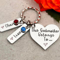 This Godmother Belongs To heart keyring with Charlie and Lizzy name tags and red and blue birthstone crystals
